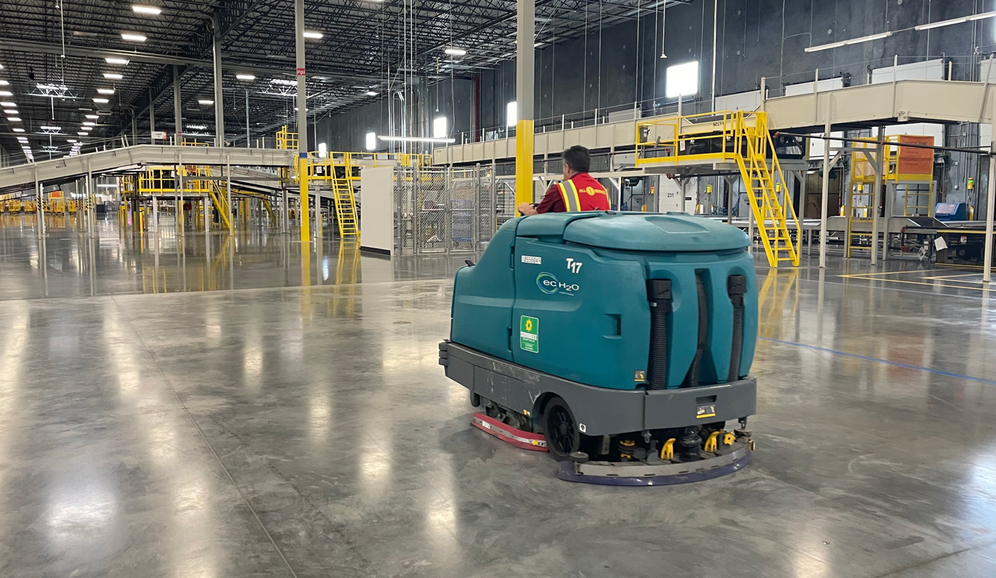 All 1 Service cleaning professionals performing commercial and industrial cleaning services at a warehouse, manufacturing facility, or commercial property.