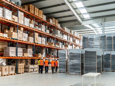 Picture of a warehouse with employees moving arounds. For warehouse cleaning services in Atlanta GA